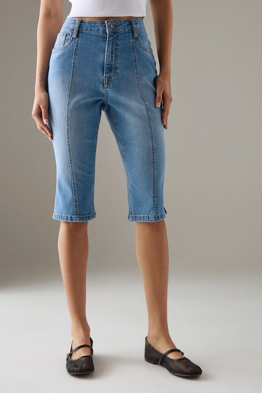 Classic knee-length denim capri with a clean, streamlined silhouette
        High-rise waistband for a flattering fit and comfortable coverage
        Traditional five-pocket styling with visible contrast stitching
        Straight-cut leg design with a neat, finished hem
        Crafted from 100% cotton for breathable comfort and durability
    
    These versatile denim capris from Warehouse strike the perfect balance between casual comfort and refined style. The high-rise design creates a sleek silhouette that pairs beautifully with both fitted and oversized tops. Style them with a crisp white crop top and an oversized leather jacket for an effortlessly cool daytime look, or dress them up with a silky blouse and pointed heels for evening drinks. The straight-cut leg offers a timeless appeal that works wonderfully for family gatherings or weekend brunches. These capris transition seamlessly between seasons - wear them with trainers and a light jumper for cooler days or with sandals and a floaty top when temperatures rise. Their durable cotton construction ensures they'll remain a wardrobe staple for years to come.