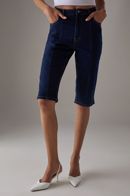 Classic knee-length denim capri with a clean, streamlined silhouette
        High-rise waistband for a flattering fit and comfortable coverage
        Traditional five-pocket styling with visible contrast stitching
        Straight-cut leg design with a neat, finished hem
        Crafted from 100% cotton for breathable comfort and durability
    
    These versatile denim capris from Warehouse strike the perfect balance between casual comfort and refined style. The high-rise design creates a sleek silhouette that pairs beautifully with both fitted and oversized tops. Style them with a crisp white crop top and an oversized leather jacket for an effortlessly cool daytime look, or dress them up with a silky blouse and pointed heels for evening drinks. The straight-cut leg offers a timeless appeal that works wonderfully for family gatherings or weekend brunches. These capris transition seamlessly between seasons - wear them with trainers and a light jumper for cooler days or with sandals and a floaty top when temperatures rise. Their durable cotton construction ensures they'll remain a wardrobe staple for years to come.