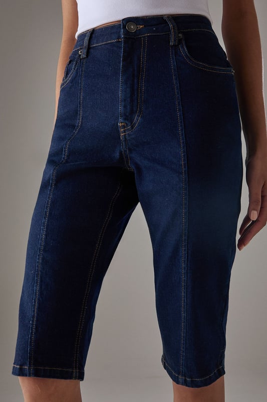 Classic knee-length denim capri with a clean, streamlined silhouette
        High-rise waistband for a flattering fit and comfortable coverage
        Traditional five-pocket styling with visible contrast stitching
        Straight-cut leg design with a neat, finished hem
        Crafted from 100% cotton for breathable comfort and durability
    
    These versatile denim capris from Warehouse strike the perfect balance between casual comfort and refined style. The high-rise design creates a sleek silhouette that pairs beautifully with both fitted and oversized tops. Style them with a crisp white crop top and an oversized leather jacket for an effortlessly cool daytime look, or dress them up with a silky blouse and pointed heels for evening drinks. The straight-cut leg offers a timeless appeal that works wonderfully for family gatherings or weekend brunches. These capris transition seamlessly between seasons - wear them with trainers and a light jumper for cooler days or with sandals and a floaty top when temperatures rise. Their durable cotton construction ensures they'll remain a wardrobe staple for years to come.