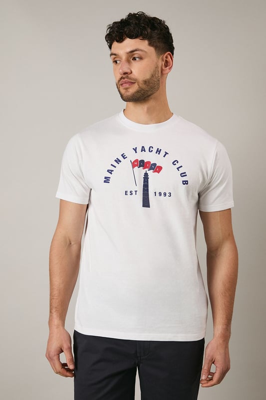Classic crew neck t-shirt featuring the distinctive Maine Yacht Club graphic print
        Short sleeves with neat ribbed trim for a clean finish
        Soft jersey fabric offering comfort for all-day wear
        Vintage-inspired nautical design with established date detail
        Relaxed fit that's perfect for casual styling
    
    This Maine Yacht Club t-shirt combines timeless nautical charm with everyday wearability. The distinctive graphic print adds character to your casual collection, whilst the comfortable jersey fabric ensures it remains a go-to piece for relaxed days. Style as seen with dark shorts and white trainers for a classic summer look that works brilliantly for weekend brunches or coastal walks. For cooler evenings, layer under a lightweight bomber jacket or denim shirt. This versatile t-shirt transitions effortlessly from daytime casual to evening gatherings with friends - simply swap the shorts for chinos and add a casual blazer to create a smart-casual ensemble that maintains its laid-back appeal. Perfect for holidays, festivals or simply enjoying the British summer.