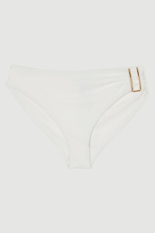 These sophisticated Karen Millen bikini bottoms bring a touch of luxury to your beachwear collection. The striking gold trim adds a refined accent that catches the light beautifully as you lounge poolside or stroll along the shore. Pair with the coordinating bandeau top for a cohesive look that's perfect for your summer getaway. Style with oversized sunglasses and a flowing kaftan for elegant poolside glamour, or team with a linen shirt and sandals when heading to a beachside lunch. These bottoms offer the perfect balance of comfort and sophistication for your next sun-soaked holiday.   Distinctive gold-tone trim detail on the side Mid-rise design offering comfortable coverage and a flattering silhouette Soft, stretchy fabric Sleek, minimalist design that pairs beautifully with the matching bandeau top  Matching piece sold separately.
