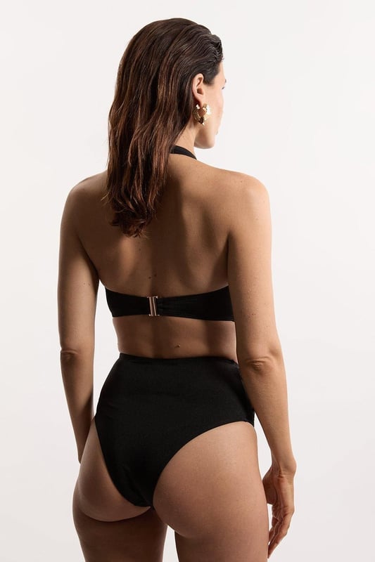 Get holiday ready in our bikini bottoms, with stitched detailing at the sides, and a full coverage design. Pairs perfectly with the matching top, sandals, and sunglasses for a holiday look perfect for lounging in the sun. Slinky Tie Detail Cheeky Bikini Bottoms Stitch Detailing at Hips Comfortable, Full Coverage Design Comfortable, High Waistline Matching Top Sold Separately Whilst appropriate for a beach destination, please note that in order to ensure enduring quality, this piece is not recommended for swimming.