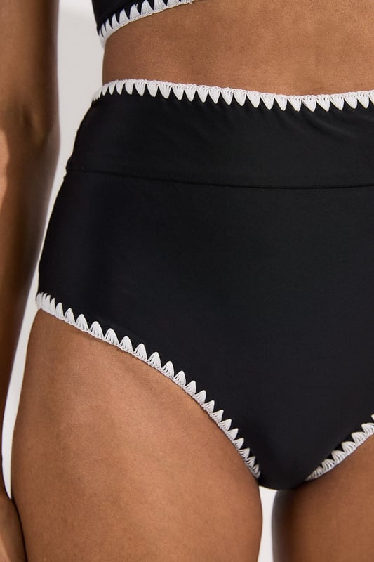 These Karen Millen high-waisted bikini bottoms high-rise design offers a timeless, sophisticated look whilst providing excellent coverage and support. Pair with the matching halter top for a coordinated ensemble that radiates poolside glamour. Perfect for lounging by the pool at exclusive resorts or enjoying coastal holidays, this swimwear piece transitions effortlessly from swimming to beachside dining when paired with a flowing kaftan and strappy sandals. This bikini set will become your go-to choice for sunny escapes and summer adventures.   High-waisted design Distinctive contrast stitch detailing Halter neck top with adjustable tie fastening Full coverage bottom  Matching piece sold separately.