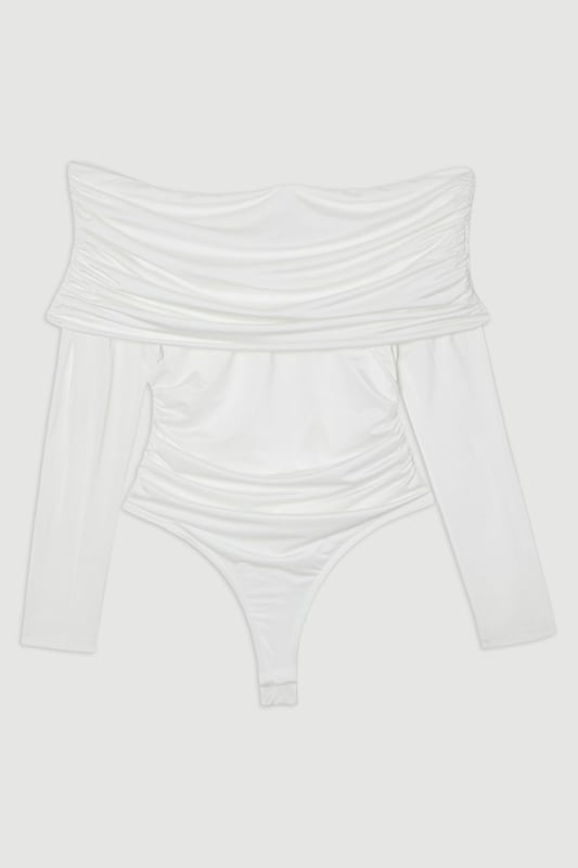 This Karen Millen Bardot bodysuit offers effortless sophistication for your everyday wardrobe. The off-shoulder design creates a flattering silhouette while the slinky jersey fabric drapes across the dcolletage. Style with high-waisted wide-leg jeans, or pair with a flowing midi skirt and ballet flats. For cooler evenings, layer with an oversized cardigan without compromising on the elegant neckline. The versatile design transitions seamlessly from daytime casual to evening drinks, simply swap to block heels and add statement earrings to transform your look.   Elegant Bardot neckline with a ruched fold-over detail Crafted from soft, drapey slinky jersey Secure bodysuit design Long sleeves