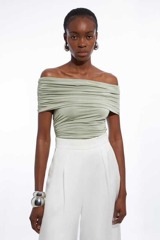 Elevate your every day wardrobe with a bodysuit, with a bodycon fit, a straight, bardot neckline which elevates the formality, and a textured, ruched design. Style it with tailored trousers or jeans and strappy heels for an occasion look that is guaranteed to turn heads wherever you step. Drapey Slinky Jersey Bardot Bodysuit High Quality, Soft Jersey Fabric Textured, Draped Design Ruched Detailing Formal Bardot Neckline Short, Off Shoulder Sleeves Bodycon Silhouette