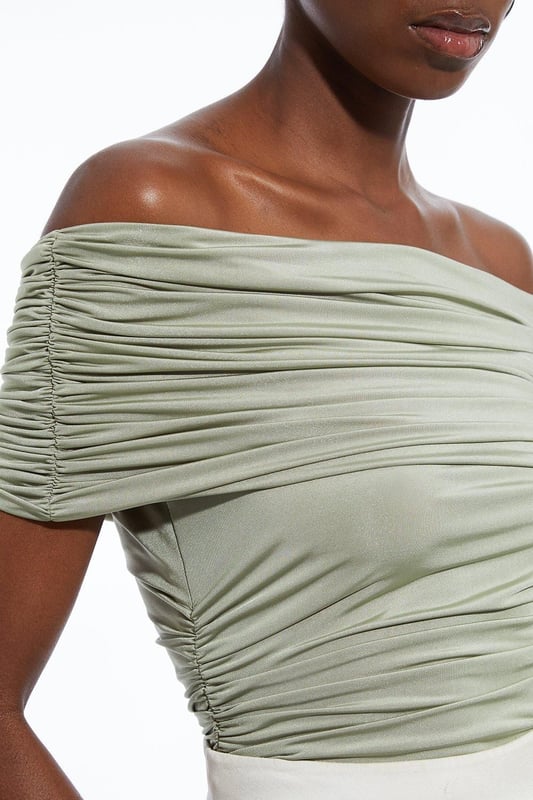 Elevate your every day wardrobe with a bodysuit, with a bodycon fit, a straight, bardot neckline which elevates the formality, and a textured, ruched design. Style it with tailored trousers or jeans and strappy heels for an occasion look that is guaranteed to turn heads wherever you step. Drapey Slinky Jersey Bardot Bodysuit High Quality, Soft Jersey Fabric Textured, Draped Design Ruched Detailing Formal Bardot Neckline Short, Off Shoulder Sleeves Bodycon Silhouette