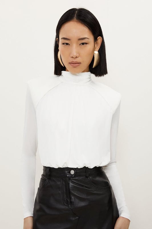 A versatile piece crafted with structured form, this piece is crafted from jersey crepe that drapes the silhouette. Featuring power shoulders and a high neck for a confident touch, finished with long sleeves.Crepe fabricHigh neckLong sleevesDiscover this seasons bodysuits or browse the full collection of women's tops now.