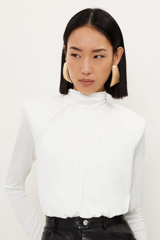 A versatile piece crafted with structured form, this piece is crafted from jersey crepe that drapes the silhouette. Featuring power shoulders and a high neck for a confident touch, finished with long sleeves.Crepe fabricHigh neckLong sleevesDiscover this seasons bodysuits or browse the full collection of women's tops now.