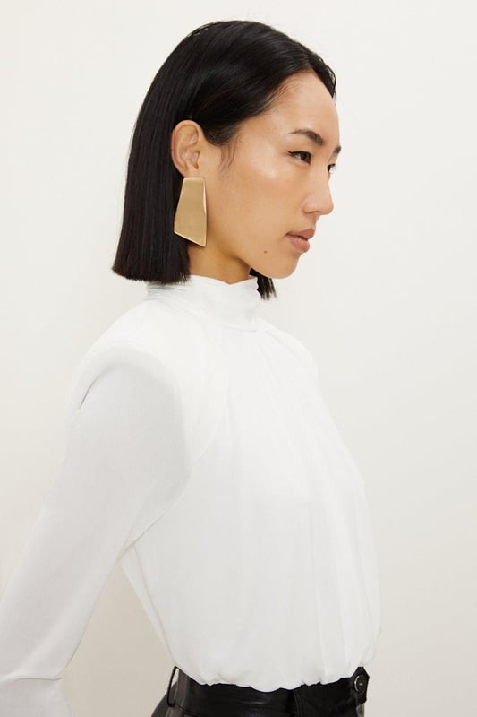 A versatile piece crafted with structured form, this piece is crafted from jersey crepe that drapes the silhouette. Featuring power shoulders and a high neck for a confident touch, finished with long sleeves.Crepe fabricHigh neckLong sleevesDiscover this seasons bodysuits or browse the full collection of women's tops now.