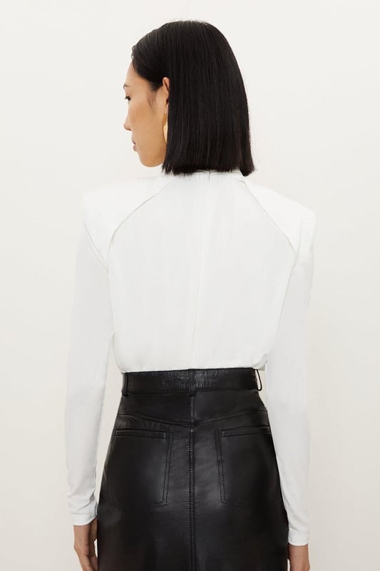 A versatile piece crafted with structured form, this piece is crafted from jersey crepe that drapes the silhouette. Featuring power shoulders and a high neck for a confident touch, finished with long sleeves.Crepe fabricHigh neckLong sleevesDiscover this seasons bodysuits or browse the full collection of women's tops now.