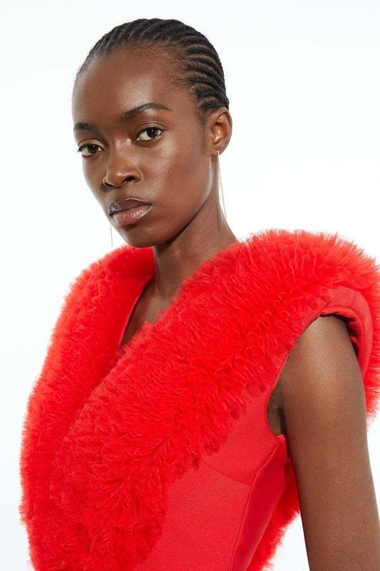 Prepare for admirable glances with this standout bodysuit. With a figure-hugging bodycon fit, and dramatic tulle detail across the shoulders, this bodysuit is set to stand out. Style with tailored trousers and strappy stilettos for an after-dark look. Bandage Figure Form Knit Tulle Detail Bodysuit Statement Tulle Detailing Deep V Neckline V Back Accent Bodycon Silhouette