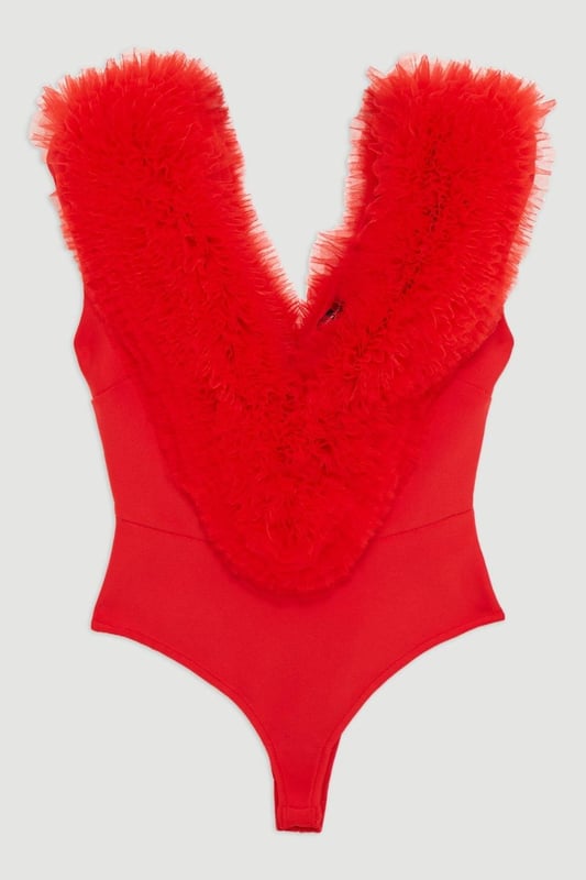 Prepare for admirable glances with this standout bodysuit. With a figure-hugging bodycon fit, and dramatic tulle detail across the shoulders, this bodysuit is set to stand out. Style with tailored trousers and strappy stilettos for an after-dark look. Bandage Figure Form Knit Tulle Detail Bodysuit Statement Tulle Detailing Deep V Neckline V Back Accent Bodycon Silhouette