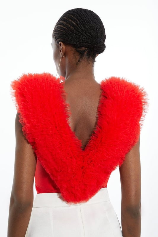 Prepare for admirable glances with this standout bodysuit. With a figure-hugging bodycon fit, and dramatic tulle detail across the shoulders, this bodysuit is set to stand out. Style with tailored trousers and strappy stilettos for an after-dark look. Bandage Figure Form Knit Tulle Detail Bodysuit Statement Tulle Detailing Deep V Neckline V Back Accent Bodycon Silhouette