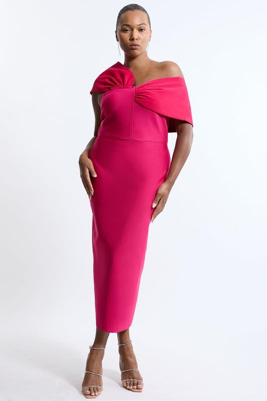 Experience opulence in our plus size midi dress, with a fitted silhouette, and an asymmetric strap design, with one that sits off the shoulder and one on the shoulder. Style it with strappy heels for an occasion look that will take you from wedding guest days to party nights. Plus Size Figure Form Bandage Knit Asymmetric Strap Midi Dress High Quality, Soft Knit Fabric Flattering Figure Hugging Fit Unique, Asymmetric Strap Detailing Thigh High Leg Split in Back Zip Fastening in Back Expertly designed for those UK size 18/US size 14 and above, our plus size clothing collection is perfectly proportioned to ensure you look stylish at every shape. Discover our collection of plus size midi dresses or browse our range of plus size clothing now.