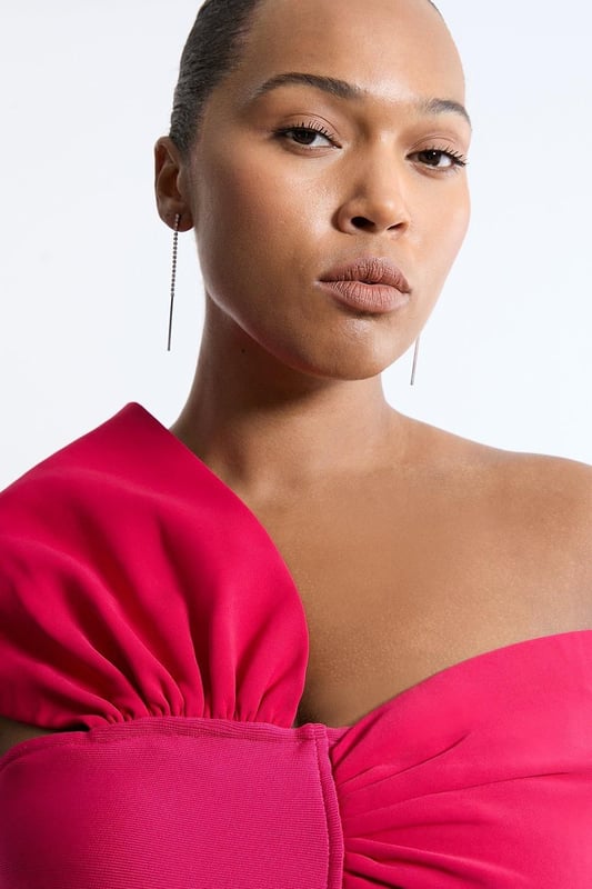 Experience opulence in our plus size midi dress, with a fitted silhouette, and an asymmetric strap design, with one that sits off the shoulder and one on the shoulder. Style it with strappy heels for an occasion look that will take you from wedding guest days to party nights. Plus Size Figure Form Bandage Knit Asymmetric Strap Midi Dress High Quality, Soft Knit Fabric Flattering Figure Hugging Fit Unique, Asymmetric Strap Detailing Thigh High Leg Split in Back Zip Fastening in Back Expertly designed for those UK size 18/US size 14 and above, our plus size clothing collection is perfectly proportioned to ensure you look stylish at every shape. Discover our collection of plus size midi dresses or browse our range of plus size clothing now.