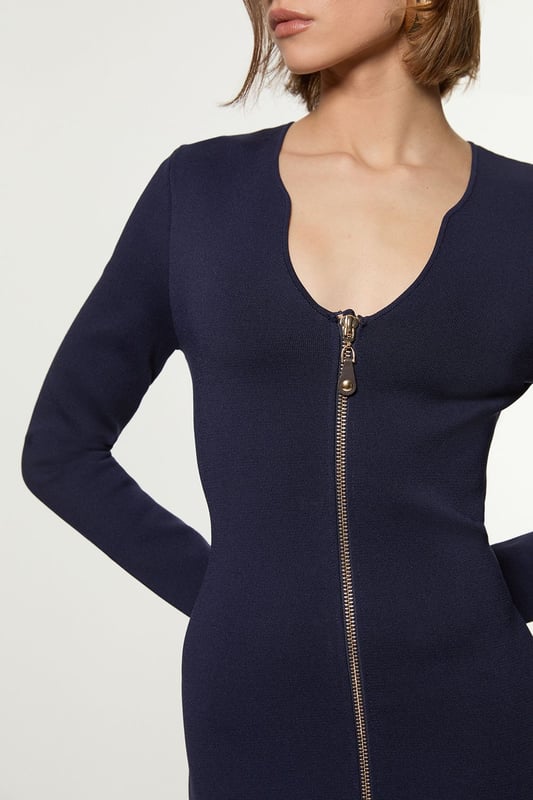 Zip Up Full Needle Knitted Dress Elevate your cold weather wardrobe in our long sleeve dress, with a fitted silhouette, metallic zip detailing, and a unique V neckline. Style it with heeled boots or chunky loafers for an elevated day to night look. Zip Up Full Needle Knitted Dress High Quality Soft Knit Fabric Flattering Figure Hugging Silhouette Rounded V Neckline Zip Front Fastening Thigh High Leg Split
