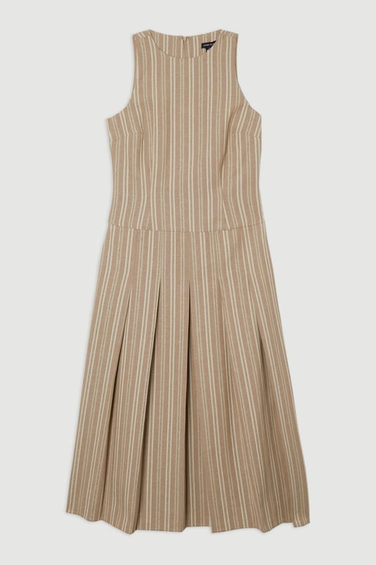 This Karen Millen tailored midi dress combines timeless stripes with contemporary design for versatile daywear. The structured bodice flows into a beautifully pleated full skirt, creating a feminine silhouette that's both comfortable and sophisticated. Style with flat leather sandals as shown for casual family gatherings or weekend brunches. For garden parties, pair with espadrille wedges and a woven clutch. The cotton-linen blend fabric offers breathability and a natural texture perfect for warmer months. This dress transitions effortlessly from day to evening, simply swap your casual footwear for block heels and add delicate gold jewellery to complement the dress's hardware detailing. A lightweight cardigan makes this piece suitable for cooler summer evenings.  Sleeveless midi dress with elegant vertical stripe pattern Sophisticated V-neckline for a flattering silhouette Full skirt design with structured pleating for graceful movement Tailored fit through bodice with defined waistline Decorative gold-tone buckle detail adds a refined finishing touch