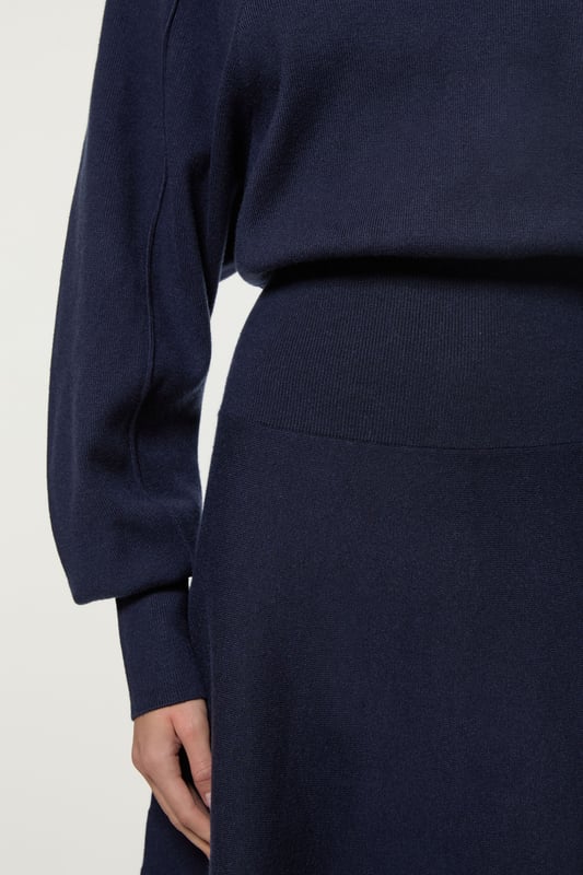 Introducing By Lydia: An Elegant Invitation - a new season collection with Lydia Millen, infused with sophistication and flair for the party season. Go seamlessly from day to night in our midi dress, made in soft knit fabric, featuring long sleeves, and a comfortable, relaxed fit that cinches at the waist to flaunt the figure. Style it simply with heeled boots or pointed toe heels for a look that will take you from date nights to upcoming parties and events. Lydia Millen Wool Look Rounded Sleeve Knit Midaxi Dress Seamless Knit Fabric Flattering Relaxed Silhouette Cinched Waistline Straight Hanging Skirt High Neckline