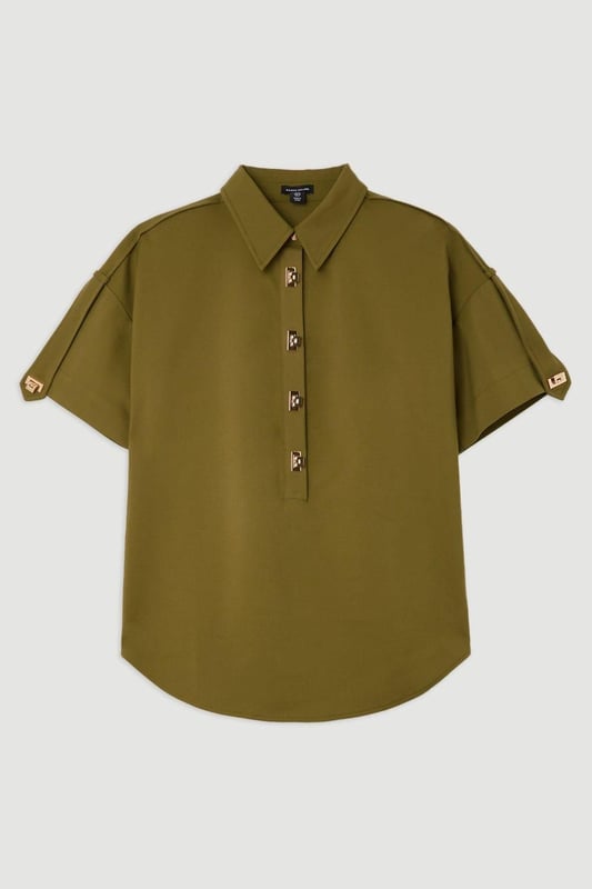 Feel formal in our shirt, with high quality cotton fabric, as well as a straight fit and short sleeves, and metallic clasp detailing down the front. Style it with anything from tailored trousers to denim jeans for looks perfect for anything from office days to dinner dates. Techno Cotton Woven Short Sleeve Hardwear Detail Shirt High Quality, Soft Cotton Fabric Flattering Straight Fit Formal Collar Accent Casual Short Sleeves Gold Clasp DetailingBrowse this seasons women's work tops or discover the full range of workwear now.Matching piece sold separately.