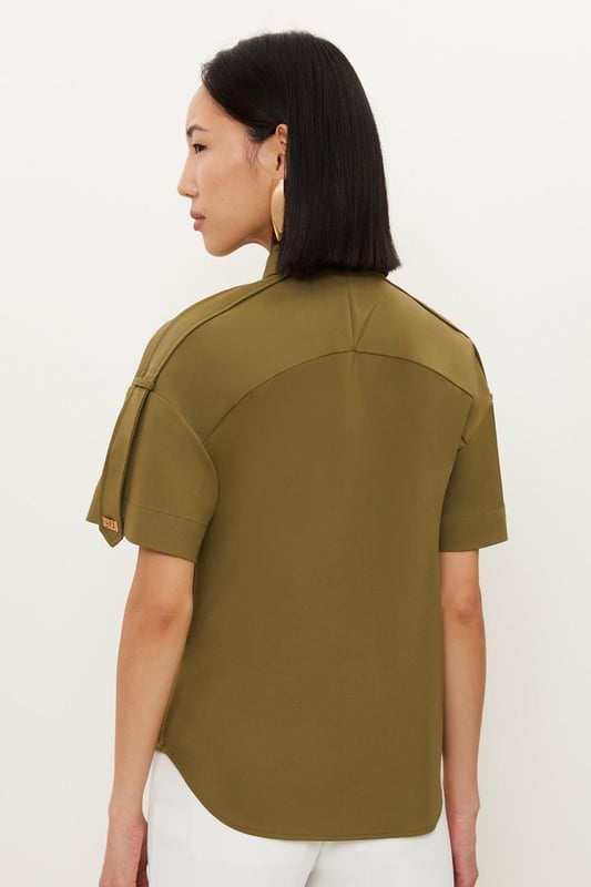 Feel formal in our shirt, with high quality cotton fabric, as well as a straight fit and short sleeves, and metallic clasp detailing down the front. Style it with anything from tailored trousers to denim jeans for looks perfect for anything from office days to dinner dates. Techno Cotton Woven Short Sleeve Hardwear Detail Shirt High Quality, Soft Cotton Fabric Flattering Straight Fit Formal Collar Accent Casual Short Sleeves Gold Clasp DetailingBrowse this seasons women's work tops or discover the full range of workwear now.Matching piece sold separately.