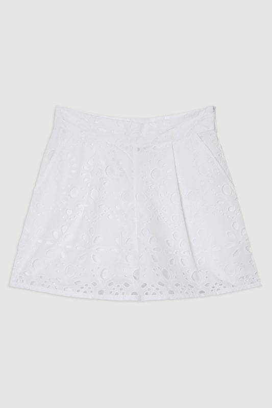 These exquisite broderie shorts from Karen Millen showcase exceptional craftsmanship with their intricate cut-out pattern. The high-waisted design creates a flattering shape that pairs with the woven shirt. For casual daywear, team with a simple tucked-in blouse and trainers for brunch with friends, or dress up with a fitted bodysuit and leather sandals for summer garden parties. The versatile length makes these shorts perfect for warm-weather holidays, simply add oversized sunglasses and a straw tote for effortless sophistication. The cotton fabric ensures breathability whilst the structured silhouette maintains shape throughout the day, making these shorts an essential addition to your warm-weather wardrobe for family gatherings and casual outings alike.  Intricate broderie anglaise detailing creates a floral pattern throughout High-waisted design with pleated front Scalloped hem with delicate cut-out pattern Side pockets