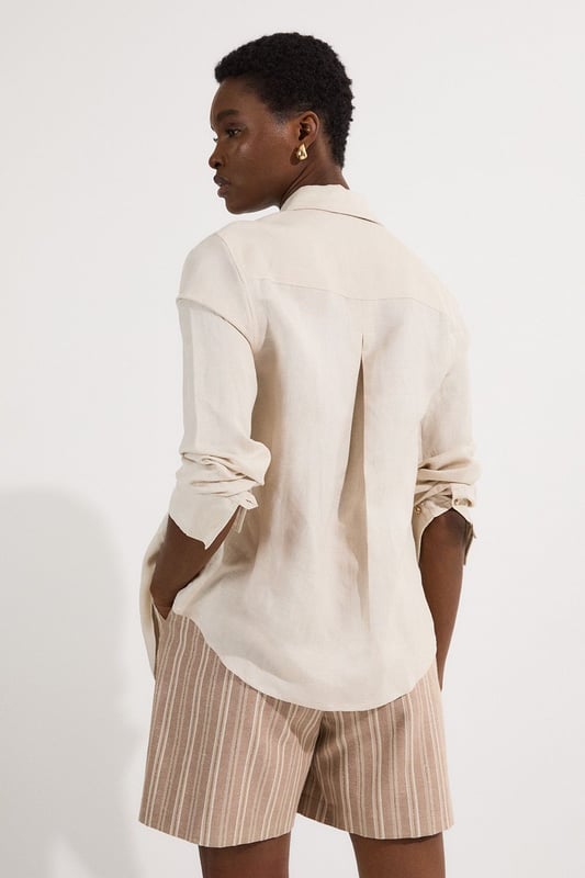 These Karen Millen tailored city shorts combine sophistication with casual comfort for effortless daywear styling. The distinctive stripe pattern with subtle sparkle threads creates visual interest while maintaining versatility. Style them with a crisp white t-shirt and an oversized blazer for a polished weekend brunch look, or pair with a lightweight knit and trainers for shopping trips and casual gatherings. The structured silhouette and linen blend fabric make these shorts perfect for warm-weather socialising without compromising on style. For a coordinated summer ensemble, match with flat sandals and a crossbody bag, adding sunglasses for a touch of chic practicality. These shorts transition seamlessly from daytime family gatherings to early evening garden parties, offering both comfort and refined style.  Tailored city shorts featuring a distinctive sparkle stripe pattern for a touch of subtle glamour Crafted with linen blend fabric for breathable comfort during warm weather Elegant gold-tone buckle detail at the waistband adds a refined finishing touch Practical side pockets for convenient storage of small essentials Versatile 45cm length offering a flattering fit that pairs beautifully with various tops  Matching piece available, sold separately.