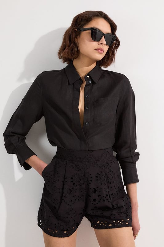 These exquisite broderie shorts from Karen Millen showcase exceptional craftsmanship with their intricate cut-out pattern. The high-waisted design creates a flattering shape that pairs with the woven shirt. For casual daywear, team with a simple tucked-in blouse and trainers for brunch with friends, or dress up with a fitted bodysuit and leather sandals for summer garden parties. The versatile length makes these shorts perfect for warm-weather holidays, simply add oversized sunglasses and a straw tote for effortless sophistication. The cotton fabric ensures breathability whilst the structured silhouette maintains shape throughout the day, making these shorts an essential addition to your warm-weather wardrobe for family gatherings and casual outings alike.  Intricate broderie anglaise detailing creates a floral pattern throughout High-waisted design with pleated front Scalloped hem with delicate cut-out pattern Side pockets