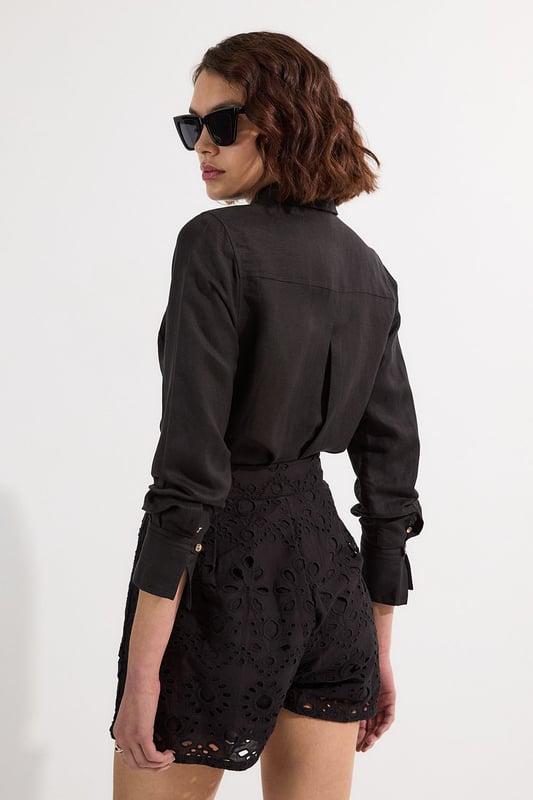 These exquisite broderie shorts from Karen Millen showcase exceptional craftsmanship with their intricate cut-out pattern. The high-waisted design creates a flattering shape that pairs with the woven shirt. For casual daywear, team with a simple tucked-in blouse and trainers for brunch with friends, or dress up with a fitted bodysuit and leather sandals for summer garden parties. The versatile length makes these shorts perfect for warm-weather holidays, simply add oversized sunglasses and a straw tote for effortless sophistication. The cotton fabric ensures breathability whilst the structured silhouette maintains shape throughout the day, making these shorts an essential addition to your warm-weather wardrobe for family gatherings and casual outings alike.  Intricate broderie anglaise detailing creates a floral pattern throughout High-waisted design with pleated front Scalloped hem with delicate cut-out pattern Side pockets