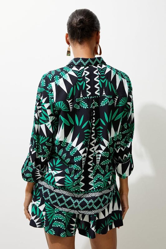 Feel warm weather ready in a pair of beach trousers, with lightweight fabric perfect for sunny days, and a relaxed fit ideal for laidback days by the pool. The geometric print makes a sunshine-approved statement, and they can easily be styled with the matching shorts or trousers and strappy sandals for a holiday outfit that goes seamlessly from day to night. Geometric Printed Viscose Woven Beach Shirt High Quality Viscose Fabric Flattering, Relaxed Fit Statement Geometric Print Rolled, Three Quarter Length Sleeves Button Front Fastenings Matching Pieces Sold SeparatelyDiscover this seasons shirts or browse the full collection of women's tops now.