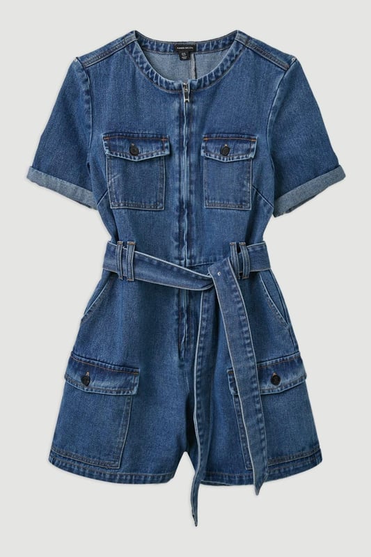 Elevate your summer wardrobe in our playsuit, with high quality denim fabric, featuring a belted waistline, as well as a utility design and relaxed fit shorts. Styles well with trainers or sandals for a summer outfit that can be worn again and again. Denim Cargo Pocket Belted Playsuit High Quality Denim Fabric Flattering Relaxed Fit Summery Short Sleeves Unique Cargo Style Zip Front Fastenings Belted Waist for a Cinched Silhouette