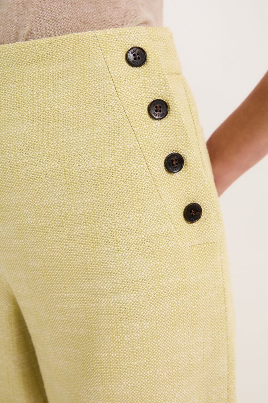 These cropped wide-leg trousers create a modern, relaxed shape while the high waistband defines your silhouette. Style with a fitted tank top for daytime sophistication, or pair with a crisp white shirt for a more structured look. The decorative button detailing adds a distinctive touch that reflects Karen Millen's attention to refined details. Perfect for family brunches, or casual workplace settings, these versatile trousers transition effortlessly from day to evening when paired with a silk blouse and strappy sandals. The neutral tone makes them an excellent foundation piece for your wardrobe, working with both bold and subtle colour palettes throughout the seasons.   Tailored wide leg trousers featuring distinctive button detailing Cropped length design High-waisted silhouette Textured tweed fabric  Matching piece sold separately.