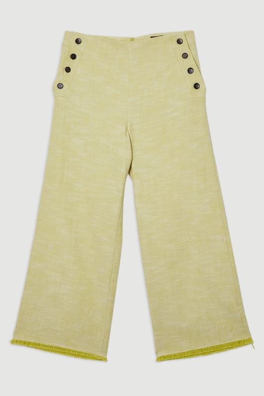 These cropped wide-leg trousers create a modern, relaxed shape while the high waistband defines your silhouette. Style with a fitted tank top for daytime sophistication, or pair with a crisp white shirt for a more structured look. The decorative button detailing adds a distinctive touch that reflects Karen Millen's attention to refined details. Perfect for family brunches, or casual workplace settings, these versatile trousers transition effortlessly from day to evening when paired with a silk blouse and strappy sandals. The neutral tone makes them an excellent foundation piece for your wardrobe, working with both bold and subtle colour palettes throughout the seasons.   Tailored wide leg trousers featuring distinctive button detailing Cropped length design High-waisted silhouette Textured tweed fabric  Matching piece sold separately.