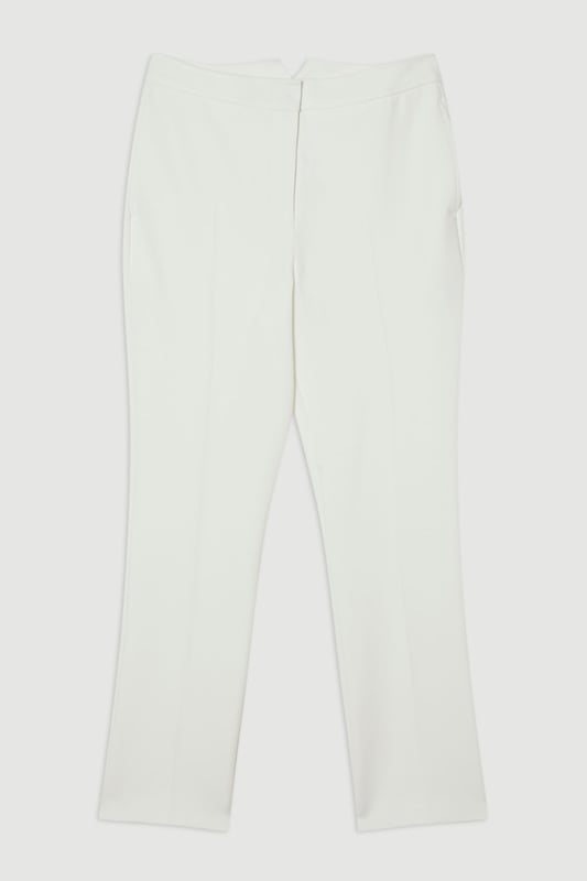 These Karen Millen tailored trousers combine professional polish with modern comfort. The slim leg design creates a refined silhouette that transitions seamlessly from boardroom to evening engagements. Style with a coordinating blazer and pointed flats for a sophisticated workwear ensemble, as shown by our model, or pair with a crisp white shirt and block heels for client meetings. The stretch-enhanced fabric allows for comfortable movement whilst maintaining structure, ideal for long days at the office. For after-work occasions, simply add statement jewellery and swap flats for elegant heels. These versatile trousers form the foundation of a capsule workwear wardrobe, offering endless styling possibilities whilst maintaining a distinctly professional appearance. Their timeless design ensures they'll remain a wardrobe staple for seasons to come.  Tailored slim leg design with clean, streamlined silhouette Stretch fabric blend for exceptional comfort and movement Sleek waistband with subtle front closure Versatile 60cm length perfect for pairing with flats or heels Sophisticated straight-leg cut that maintains its shape throughout the day  Matching piece sold separately.