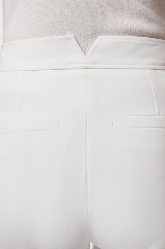 These Karen Millen tailored trousers combine professional polish with modern comfort. The slim leg design creates a refined silhouette that transitions seamlessly from boardroom to evening engagements. Style with a coordinating blazer and pointed flats for a sophisticated workwear ensemble, as shown by our model, or pair with a crisp white shirt and block heels for client meetings. The stretch-enhanced fabric allows for comfortable movement whilst maintaining structure, ideal for long days at the office. For after-work occasions, simply add statement jewellery and swap flats for elegant heels. These versatile trousers form the foundation of a capsule workwear wardrobe, offering endless styling possibilities whilst maintaining a distinctly professional appearance. Their timeless design ensures they'll remain a wardrobe staple for seasons to come.  Tailored slim leg design with clean, streamlined silhouette Stretch fabric blend for exceptional comfort and movement Sleek waistband with subtle front closure Versatile 60cm length perfect for pairing with flats or heels Sophisticated straight-leg cut that maintains its shape throughout the day  Matching piece sold separately.