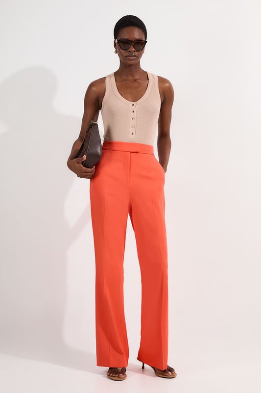 These Karen Millen tailored kick flare trousers present the perfect balance of contemporary style and classic workwear sophistication. The high-rise waistband creates a flattering shape that elongates the legs, while the subtle flare adds a modern twist to traditional office attire. Style them with a fitted button-front vest and coordinating blazer for a powerful suited look, or pair them with a crisp cotton shirt and court shoes for everyday elegance. The versatile design transitions seamlessly from important meetings to after-work gatherings, simply swap your structured tote for a clutch and add statement jewellery.  Tailored high-waisted design Kick flare shape Clean, minimalist styling Viscose-blend fabric