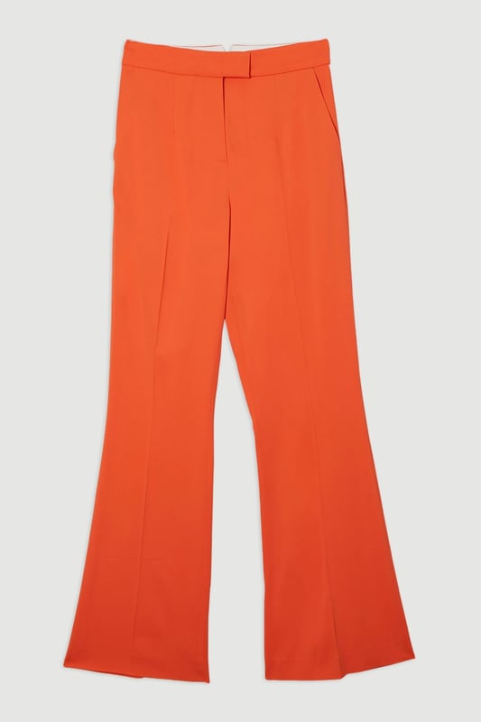 These Karen Millen tailored kick flare trousers present the perfect balance of contemporary style and classic workwear sophistication. The high-rise waistband creates a flattering shape that elongates the legs, while the subtle flare adds a modern twist to traditional office attire. Style them with a fitted button-front vest and coordinating blazer for a powerful suited look, or pair them with a crisp cotton shirt and court shoes for everyday elegance. The versatile design transitions seamlessly from important meetings to after-work gatherings, simply swap your structured tote for a clutch and add statement jewellery.  Tailored high-waisted design Kick flare shape Clean, minimalist styling Viscose-blend fabric