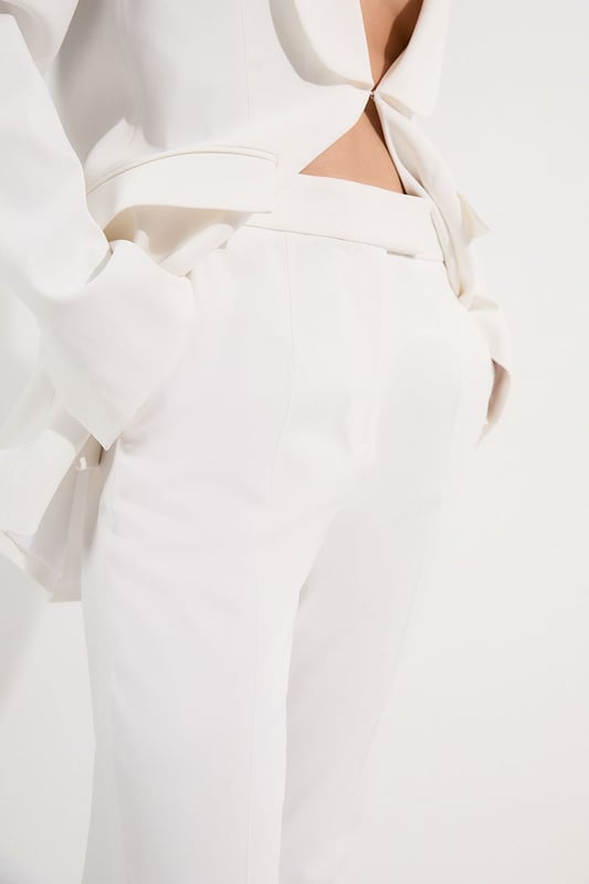 These Karen Millen tailored kick flare trousers present the perfect balance of contemporary style and classic workwear sophistication. The high-rise waistband creates a flattering shape that elongates the legs, while the subtle flare adds a modern twist to traditional office attire. Style them with a fitted button-front vest and coordinating blazer for a powerful suited look, or pair them with a crisp cotton shirt and court shoes for everyday elegance. The versatile design transitions seamlessly from important meetings to after-work gatherings, simply swap your structured tote for a clutch and add statement jewellery.  Tailored high-waisted design Kick flare shape Clean, minimalist styling Viscose-blend fabric