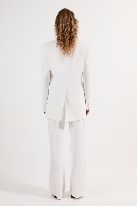 These Karen Millen tailored kick flare trousers present the perfect balance of contemporary style and classic workwear sophistication. The high-rise waistband creates a flattering shape that elongates the legs, while the subtle flare adds a modern twist to traditional office attire. Style them with a fitted button-front vest and coordinating blazer for a powerful suited look, or pair them with a crisp cotton shirt and court shoes for everyday elegance. The versatile design transitions seamlessly from important meetings to after-work gatherings, simply swap your structured tote for a clutch and add statement jewellery.  Tailored high-waisted design Kick flare shape Clean, minimalist styling Viscose-blend fabric