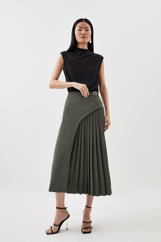 Feel elegant in our midi skirt, with a universally flattering silhouette, pleated detailing, and a high waistline, perfect for getting a little dressed up. Style this piece with strappy heels for an outfit that will turn heads from office days to upcoming occasions and events. Tailored Buckle Detail Pleated Midi Skirt Formal, Flowing Fit High Waistline Unique Pleated Panel Midi Length Metallic Buckle at WaistlineBrowse this seasons work skirts or discover the full range of workwear now.