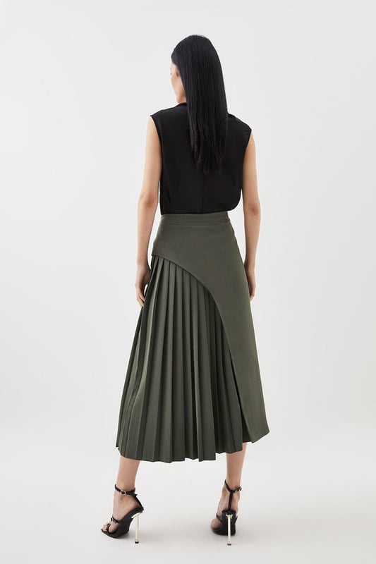 Feel elegant in our midi skirt, with a universally flattering silhouette, pleated detailing, and a high waistline, perfect for getting a little dressed up. Style this piece with strappy heels for an outfit that will turn heads from office days to upcoming occasions and events. Tailored Buckle Detail Pleated Midi Skirt Formal, Flowing Fit High Waistline Unique Pleated Panel Midi Length Metallic Buckle at WaistlineBrowse this seasons work skirts or discover the full range of workwear now.