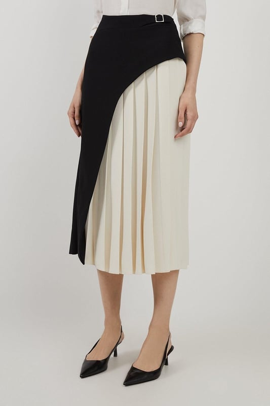 Feel elegant in our midi skirt, with a universally flattering silhouette, pleated detailing, and a high waistline, perfect for getting a little dressed up. Style this piece with strappy heels for an outfit that will turn heads from office days to upcoming occasions and events. Tailored Buckle Detail Pleated Midi Skirt Formal, Flowing Fit High Waistline Unique Pleated Panel Midi Length Metallic Buckle at WaistlineBrowse this seasons work skirts or discover the full range of workwear now.