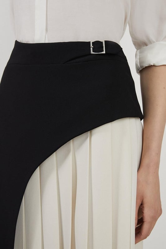 Feel elegant in our midi skirt, with a universally flattering silhouette, pleated detailing, and a high waistline, perfect for getting a little dressed up. Style this piece with strappy heels for an outfit that will turn heads from office days to upcoming occasions and events. Tailored Buckle Detail Pleated Midi Skirt Formal, Flowing Fit High Waistline Unique Pleated Panel Midi Length Metallic Buckle at WaistlineBrowse this seasons work skirts or discover the full range of workwear now.