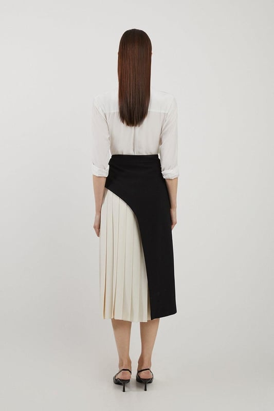 Feel elegant in our midi skirt, with a universally flattering silhouette, pleated detailing, and a high waistline, perfect for getting a little dressed up. Style this piece with strappy heels for an outfit that will turn heads from office days to upcoming occasions and events. Tailored Buckle Detail Pleated Midi Skirt Formal, Flowing Fit High Waistline Unique Pleated Panel Midi Length Metallic Buckle at WaistlineBrowse this seasons work skirts or discover the full range of workwear now.