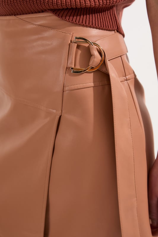 This Karen Millen wrap midi skirt showcases sophisticated urban style with its distinctive tie detail and statement buckle. The asymmetric wrap design creates a flattering silhouette. For family gatherings or brunches with friends, team with a fine knit jumper and trainers for an effortlessly stylish look. The versatile midi length makes this piece ideal for transitional weather, while the faux leather texture adds a contemporary touch to your wardrobe.   Striking wrap design with elegant tie detail Distinctive buckle hardware Midi length Faux leather
