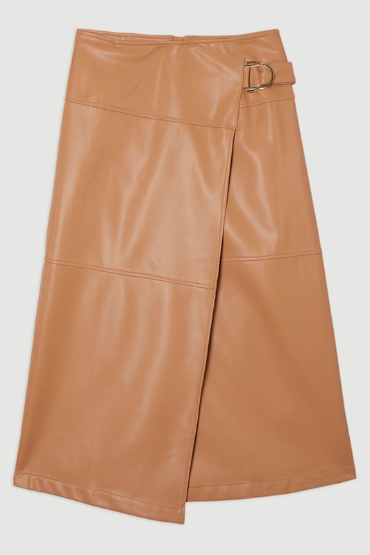This Karen Millen wrap midi skirt showcases sophisticated urban style with its distinctive tie detail and statement buckle. The asymmetric wrap design creates a flattering silhouette. For family gatherings or brunches with friends, team with a fine knit jumper and trainers for an effortlessly stylish look. The versatile midi length makes this piece ideal for transitional weather, while the faux leather texture adds a contemporary touch to your wardrobe.   Striking wrap design with elegant tie detail Distinctive buckle hardware Midi length Faux leather