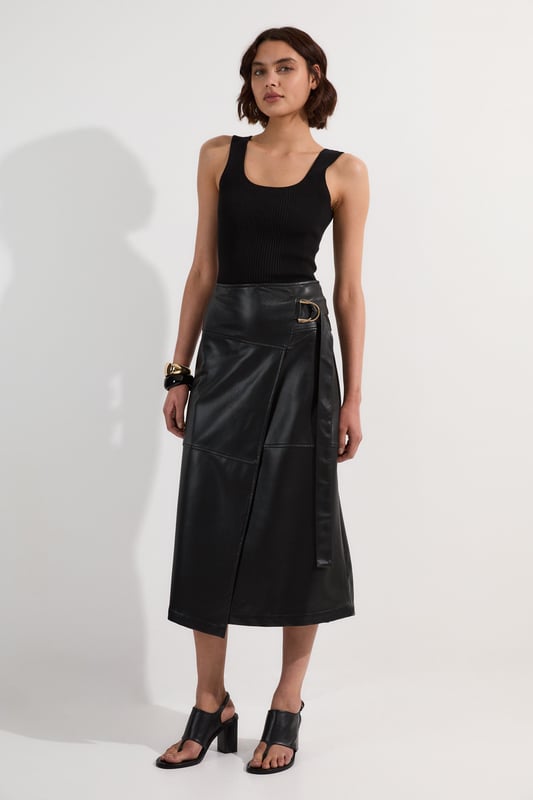 This Karen Millen wrap midi skirt showcases sophisticated urban style with its distinctive tie detail and statement buckle. The asymmetric wrap design creates a flattering silhouette. For family gatherings or brunches with friends, team with a fine knit jumper and trainers for an effortlessly stylish look. The versatile midi length makes this piece ideal for transitional weather, while the faux leather texture adds a contemporary touch to your wardrobe.   Striking wrap design with elegant tie detail Distinctive buckle hardware Midi length Faux leather