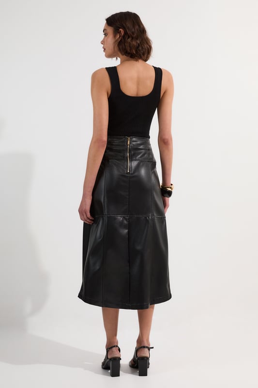 This Karen Millen wrap midi skirt showcases sophisticated urban style with its distinctive tie detail and statement buckle. The asymmetric wrap design creates a flattering silhouette. For family gatherings or brunches with friends, team with a fine knit jumper and trainers for an effortlessly stylish look. The versatile midi length makes this piece ideal for transitional weather, while the faux leather texture adds a contemporary touch to your wardrobe.   Striking wrap design with elegant tie detail Distinctive buckle hardware Midi length Faux leather
