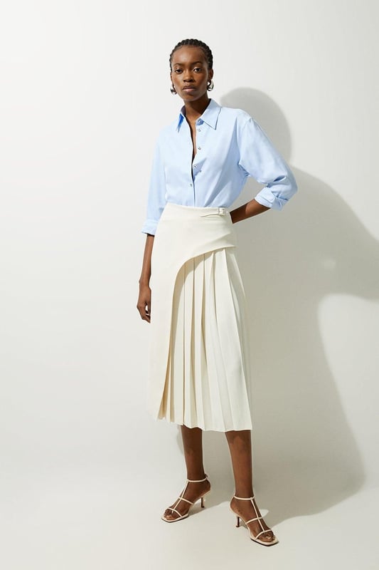 Feel elegant in our midi skirt, with a universally flattering silhouette, pleated detailing, and a high waistline, perfect for getting a little dressed up. Style this piece with strappy heels for an outfit that will turn heads from office days to upcoming occasions and events. Tailored Buckle Detail Pleated Midi Skirt Formal, Flowing Fit High Waistline Unique Pleated Panel Midi Length Metallic Buckle at WaistlineBrowse this seasons work skirts or discover the full range of workwear now.