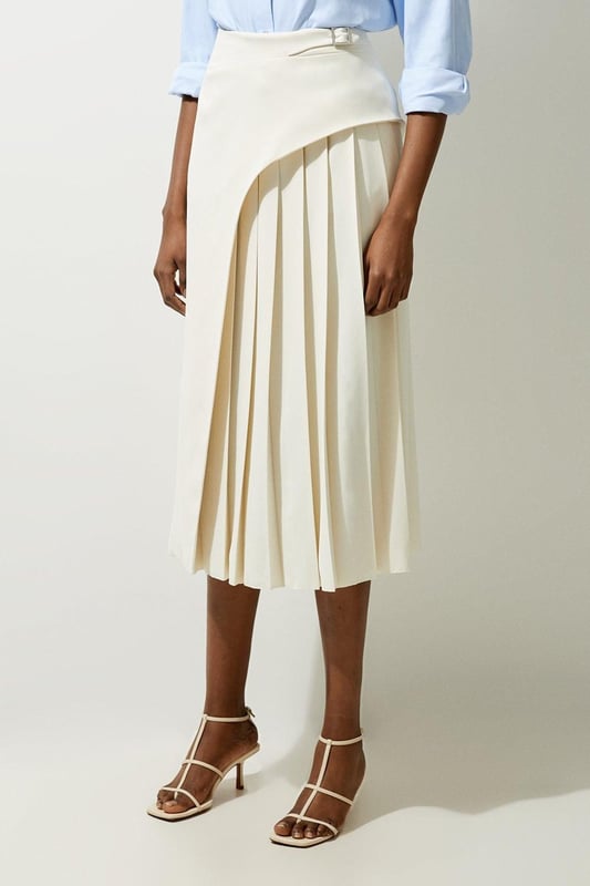 Feel elegant in our midi skirt, with a universally flattering silhouette, pleated detailing, and a high waistline, perfect for getting a little dressed up. Style this piece with strappy heels for an outfit that will turn heads from office days to upcoming occasions and events. Tailored Buckle Detail Pleated Midi Skirt Formal, Flowing Fit High Waistline Unique Pleated Panel Midi Length Metallic Buckle at WaistlineBrowse this seasons work skirts or discover the full range of workwear now.
