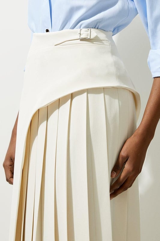 Feel elegant in our midi skirt, with a universally flattering silhouette, pleated detailing, and a high waistline, perfect for getting a little dressed up. Style this piece with strappy heels for an outfit that will turn heads from office days to upcoming occasions and events. Tailored Buckle Detail Pleated Midi Skirt Formal, Flowing Fit High Waistline Unique Pleated Panel Midi Length Metallic Buckle at WaistlineBrowse this seasons work skirts or discover the full range of workwear now.